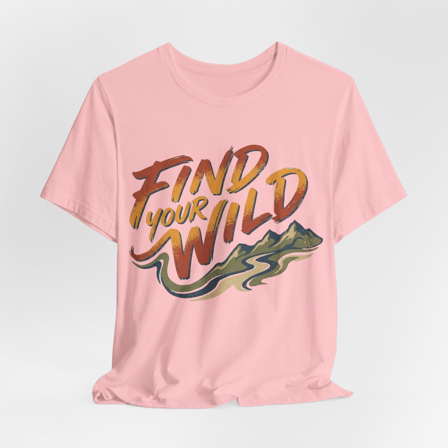 Pink t-shirt with 'Find Your Wild' text and mountain graphic on a light gray background