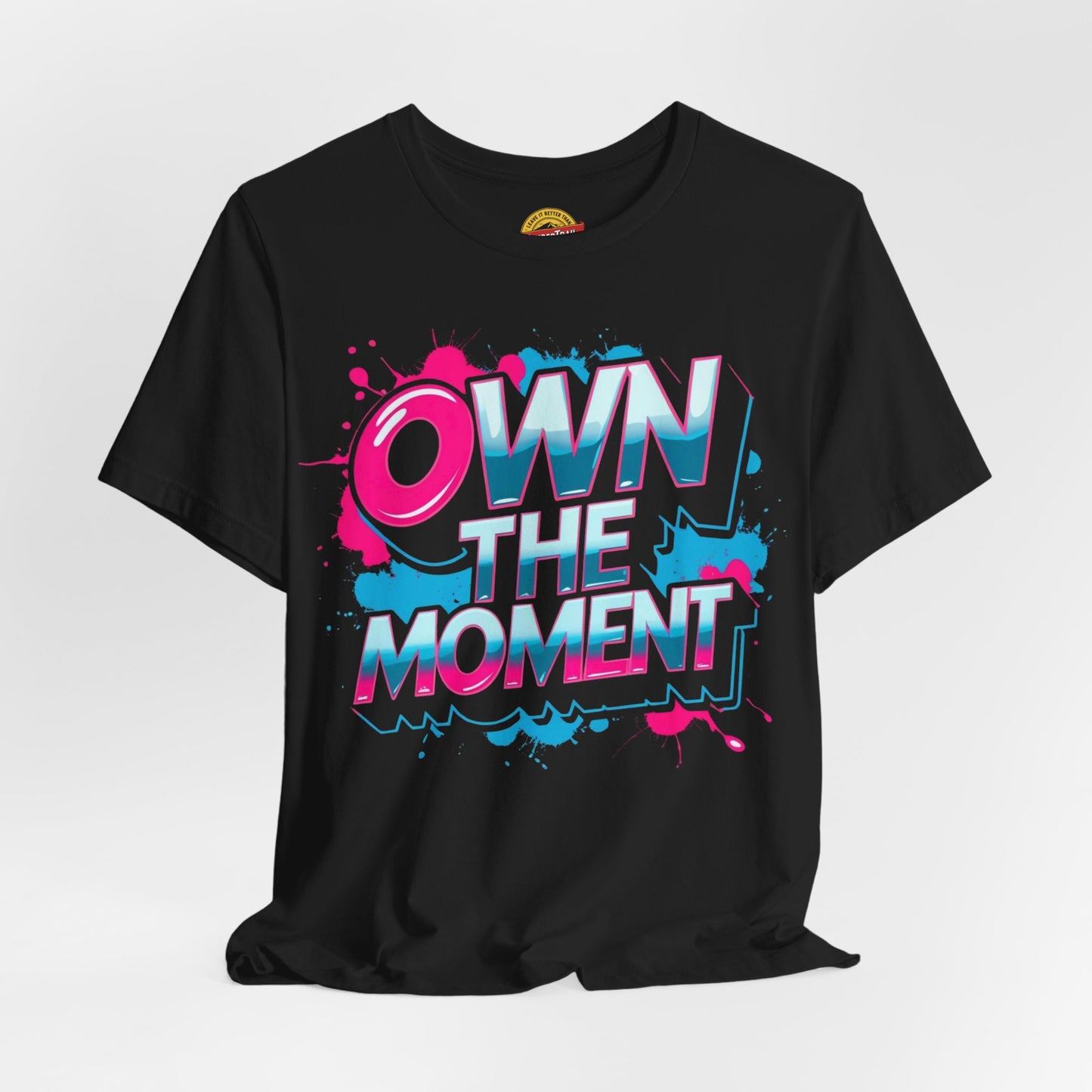 Black t-shirt with 'OWN THE MOMENT' graphic design on a white background