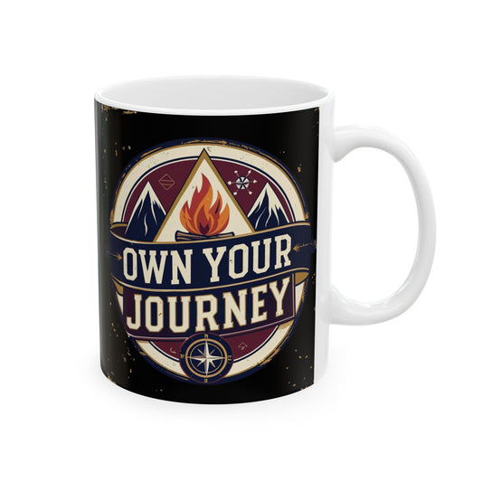 Mug with 'Own Your Journey' design featuring a campfire and mountains on a black background