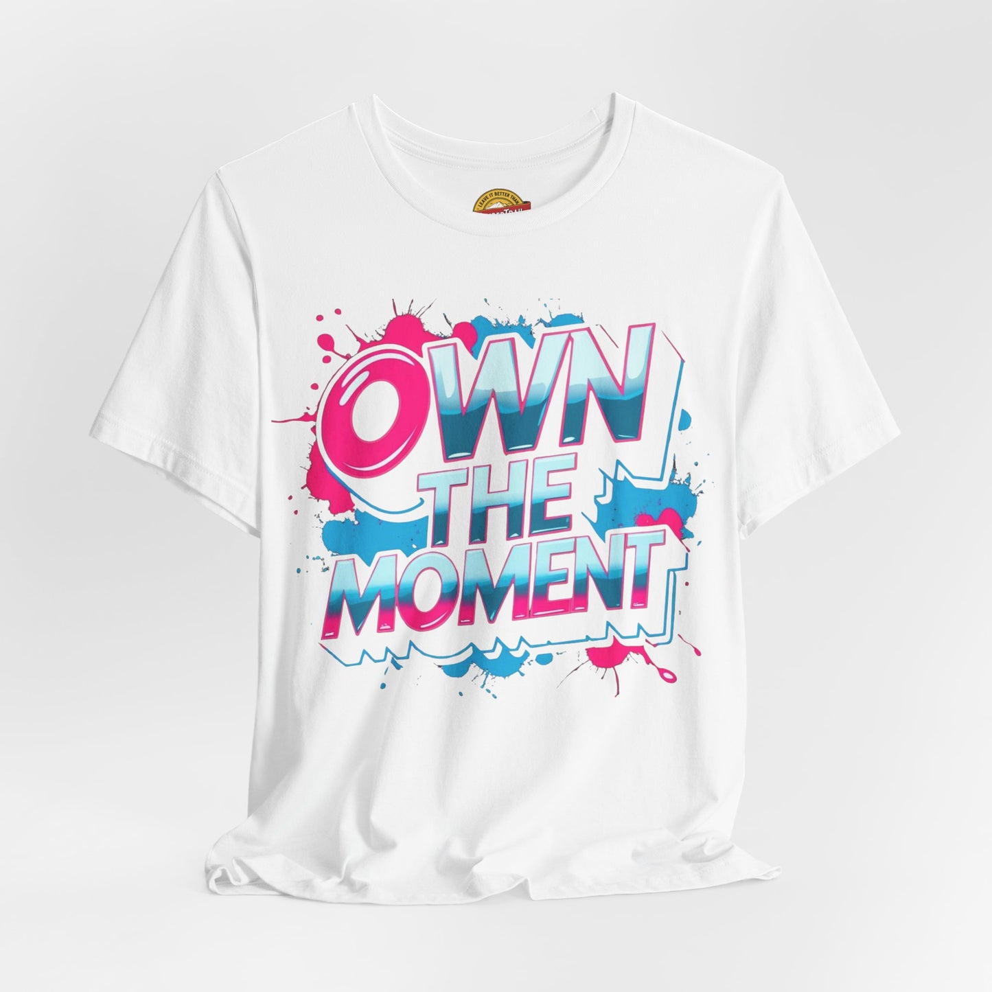 White t-shirt with 'OWN THE MOMENT' graphic design on a white background
