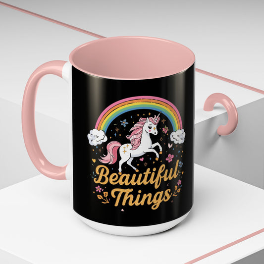 Black mug with pink interior and handle, featuring a unicorn and rainbow design with 'Beautiful Things' text.
