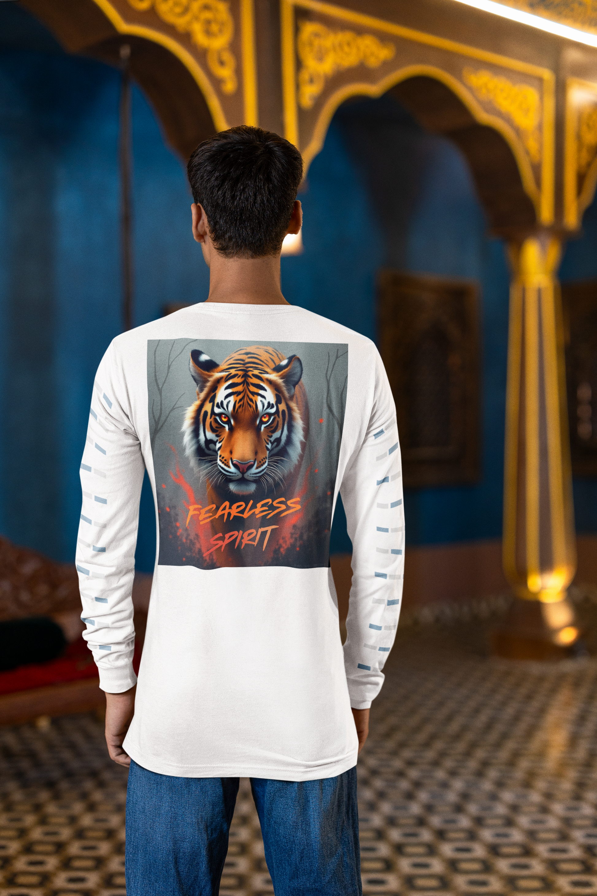Person wearing a white long-sleeve shirt with a tiger graphic and 'Fearless Spirit' text in an indoor setting.
