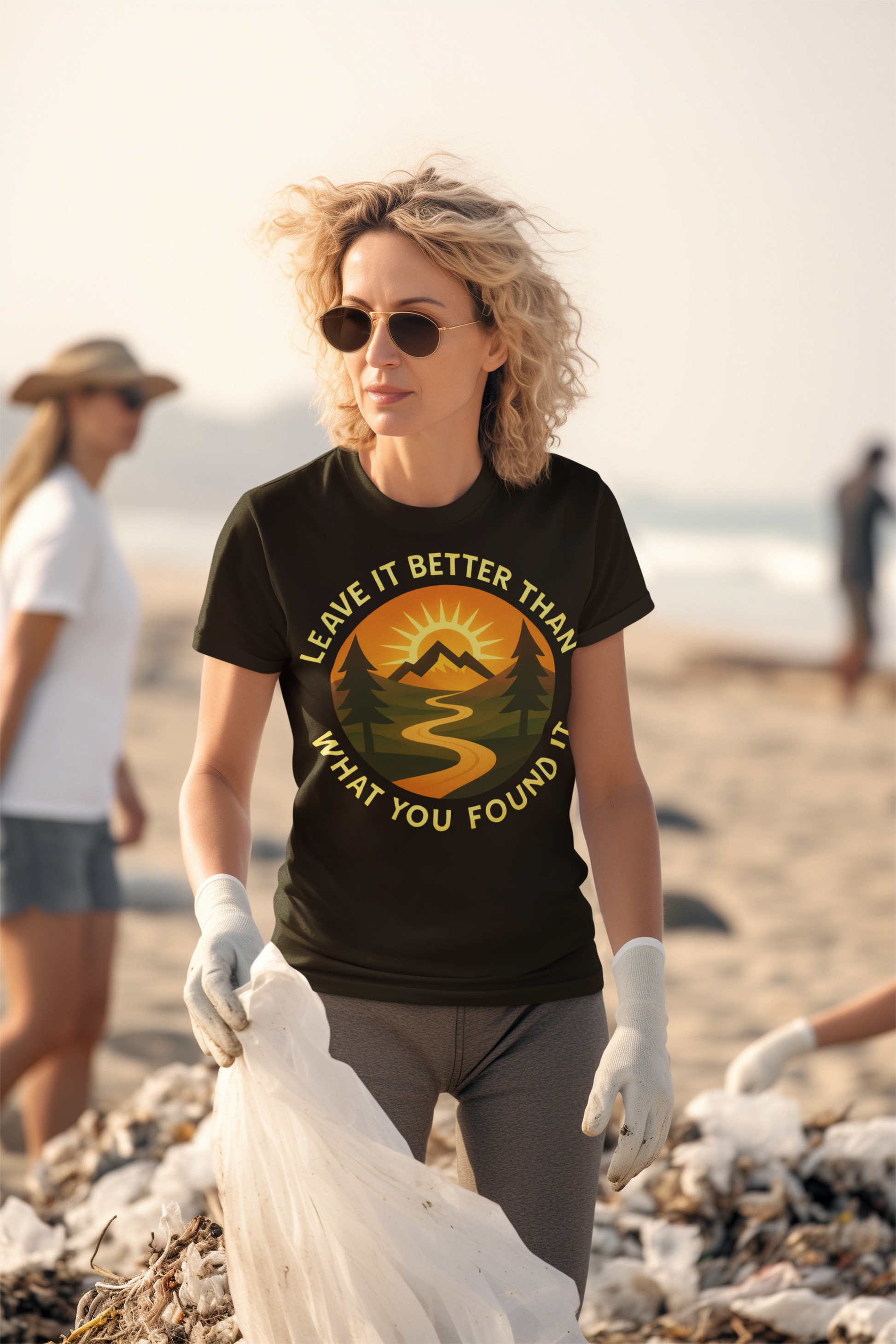Woman on a beach wearing a t-shirt with a sustainability message, holding a plastic bag.