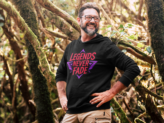 Man wearing a black hoodie with 'Legends Never Fade' text in a forest setting
