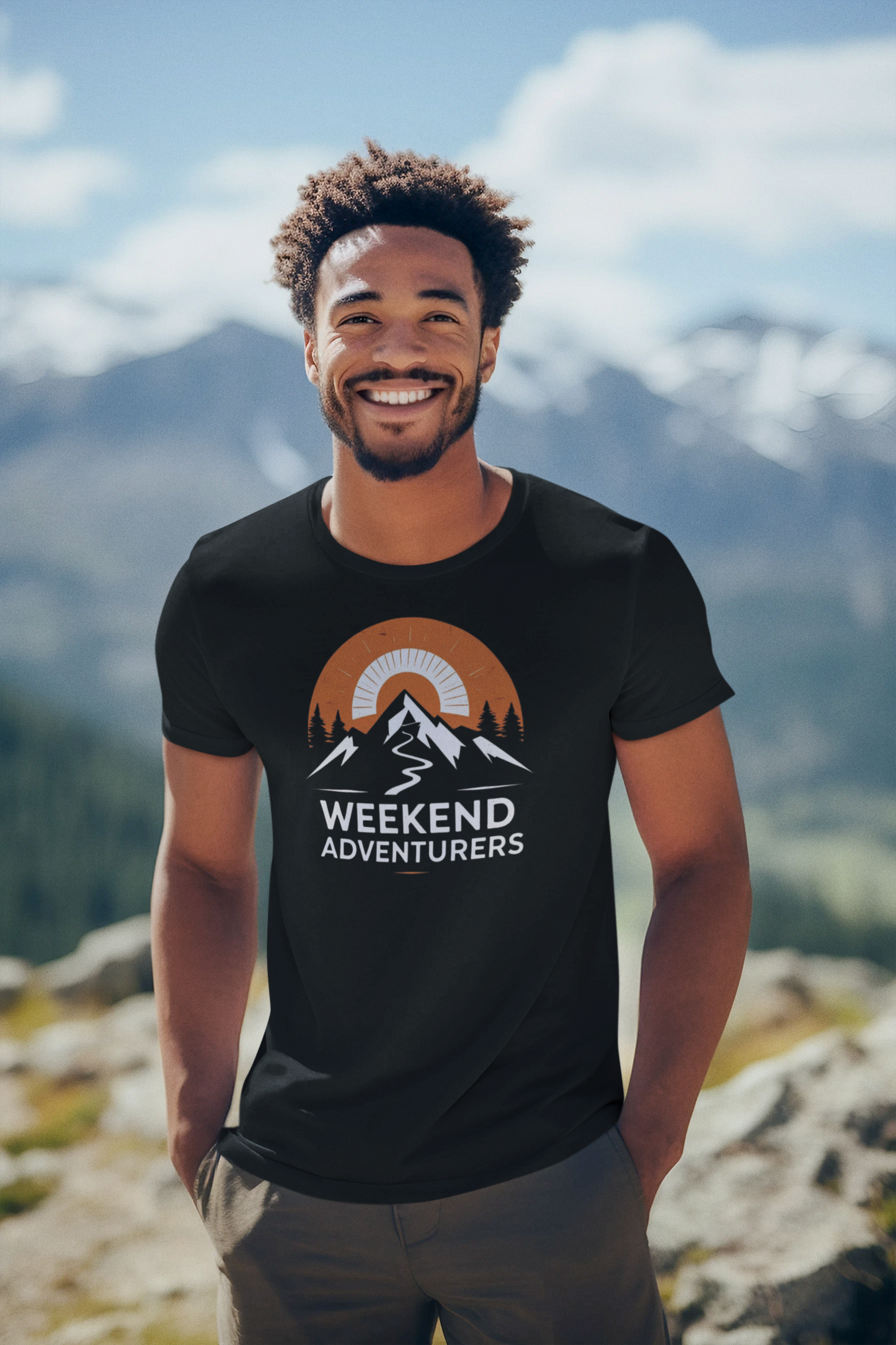 Man wearing a black t-shirt with 'Weekend Adventurers' design in a mountainous landscape
