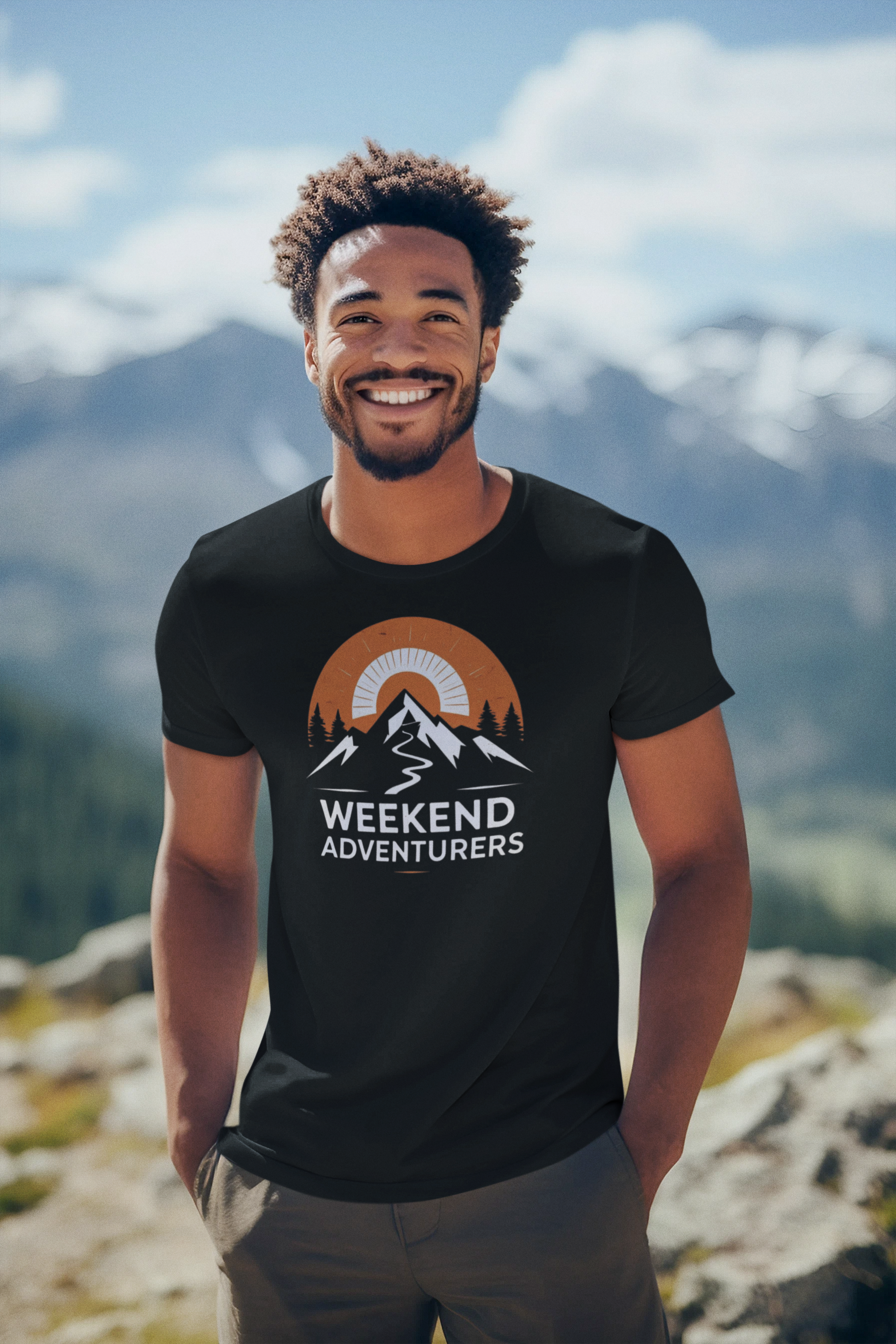 Man wearing a black t-shirt with 'Weekend Adventurers' design in a mountainous landscape