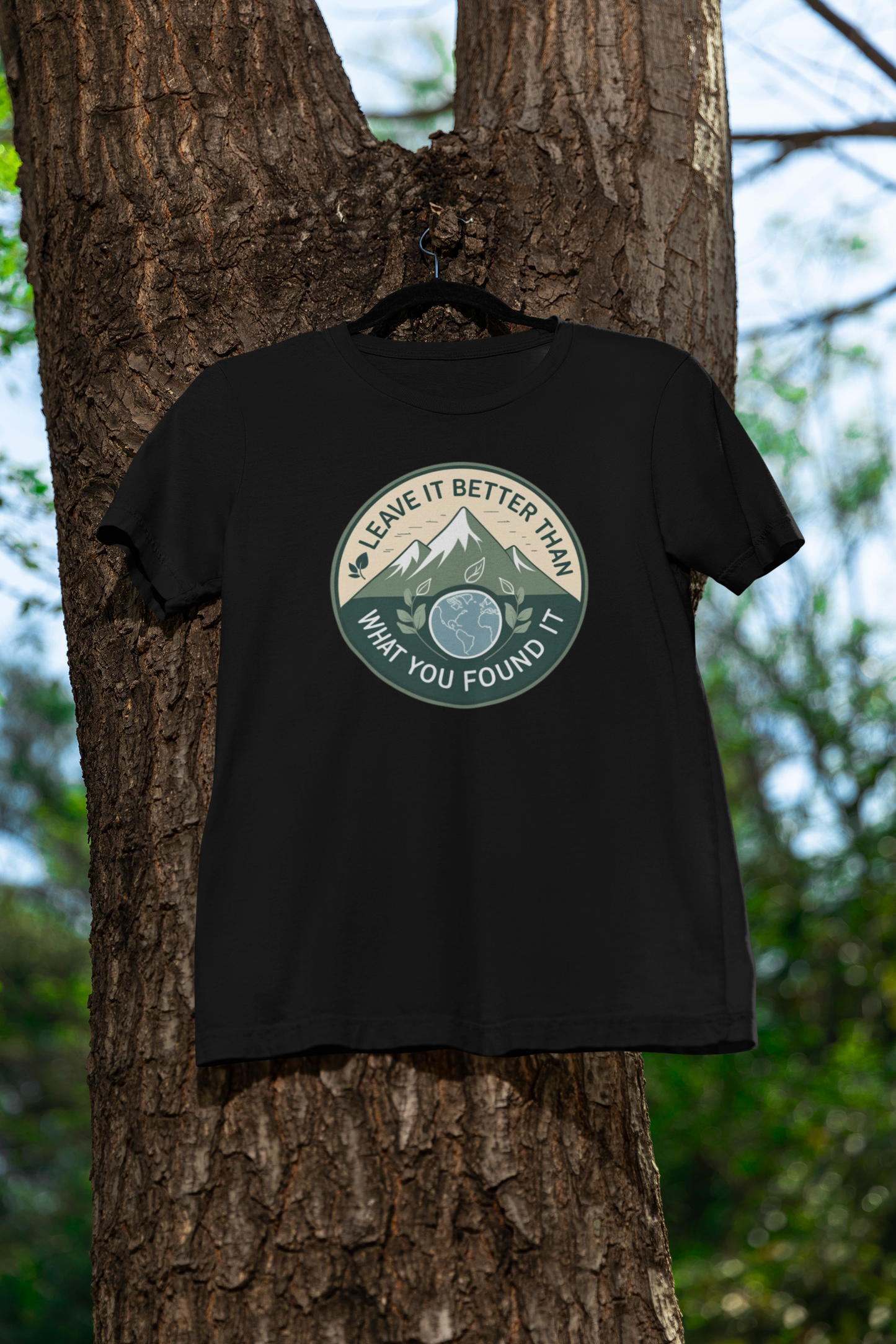 Black t-shirt with a graphic design hanging on a tree