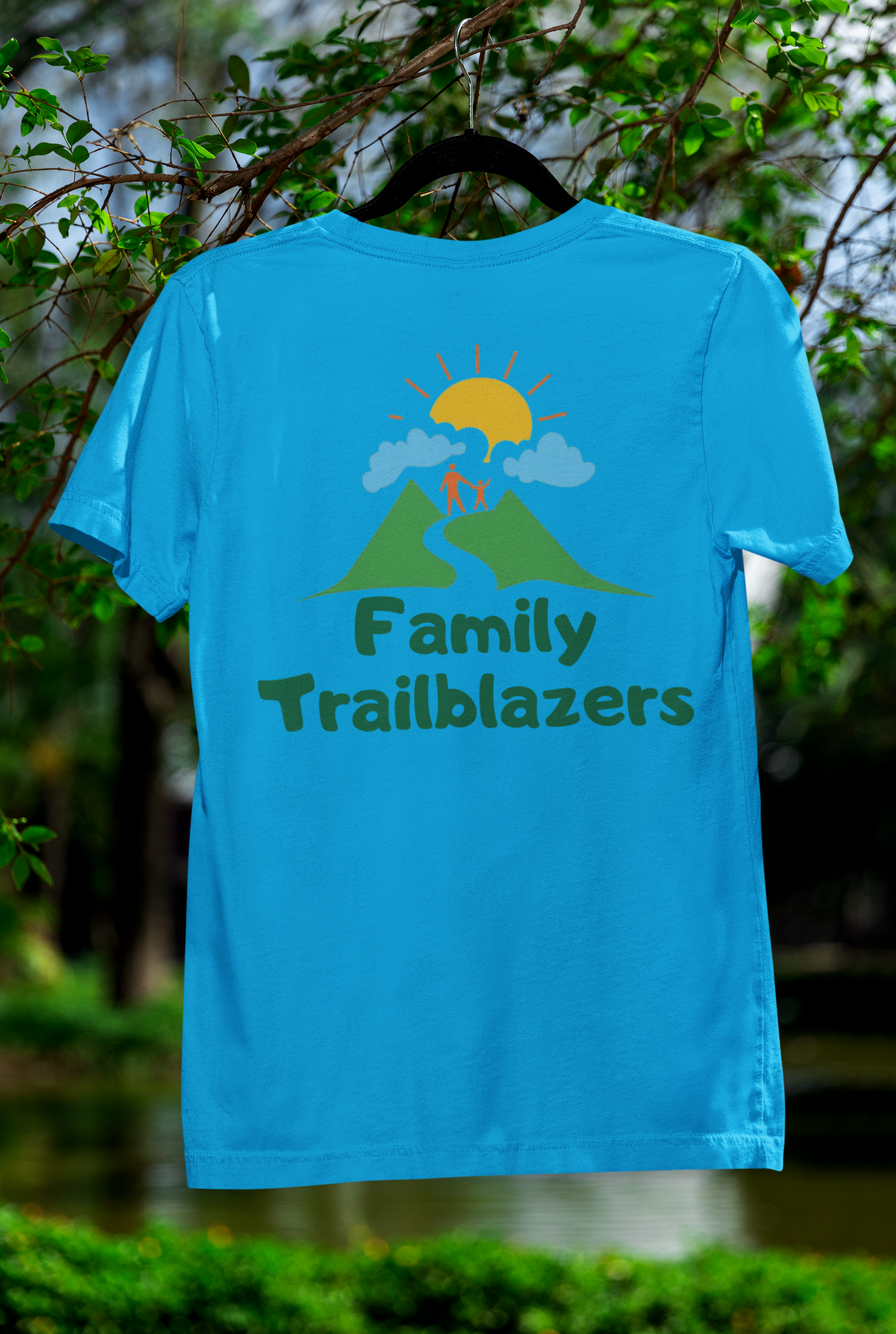 Blue t-shirt with 'Family Trailblazers' design hanging against a natural background