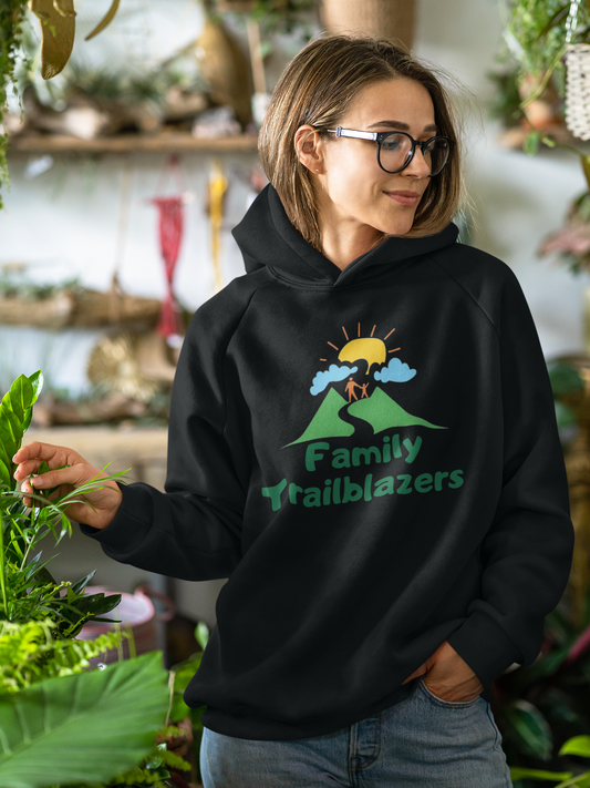 Woman wearing a black hoodie with 'Family Trailblazers' design in an indoor setting.