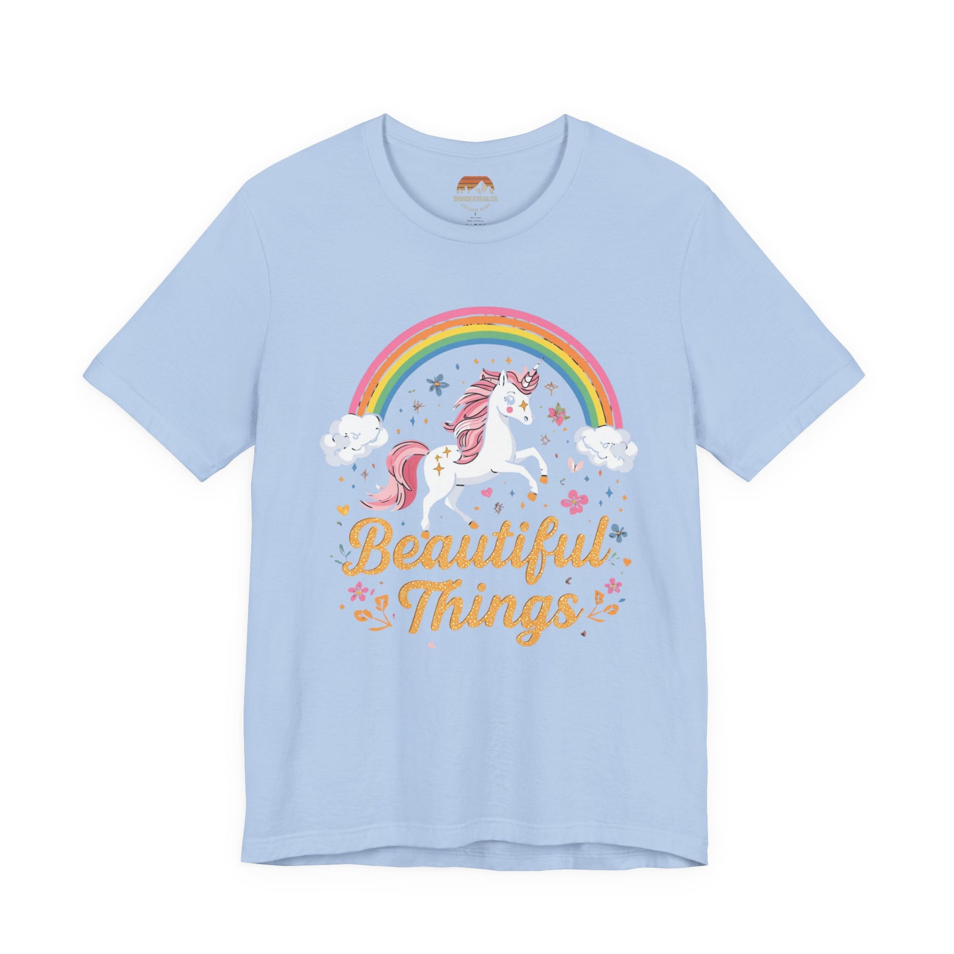 Light blue t-shirt with a unicorn and rainbow graphic and 'Beautiful Things' text on a white background