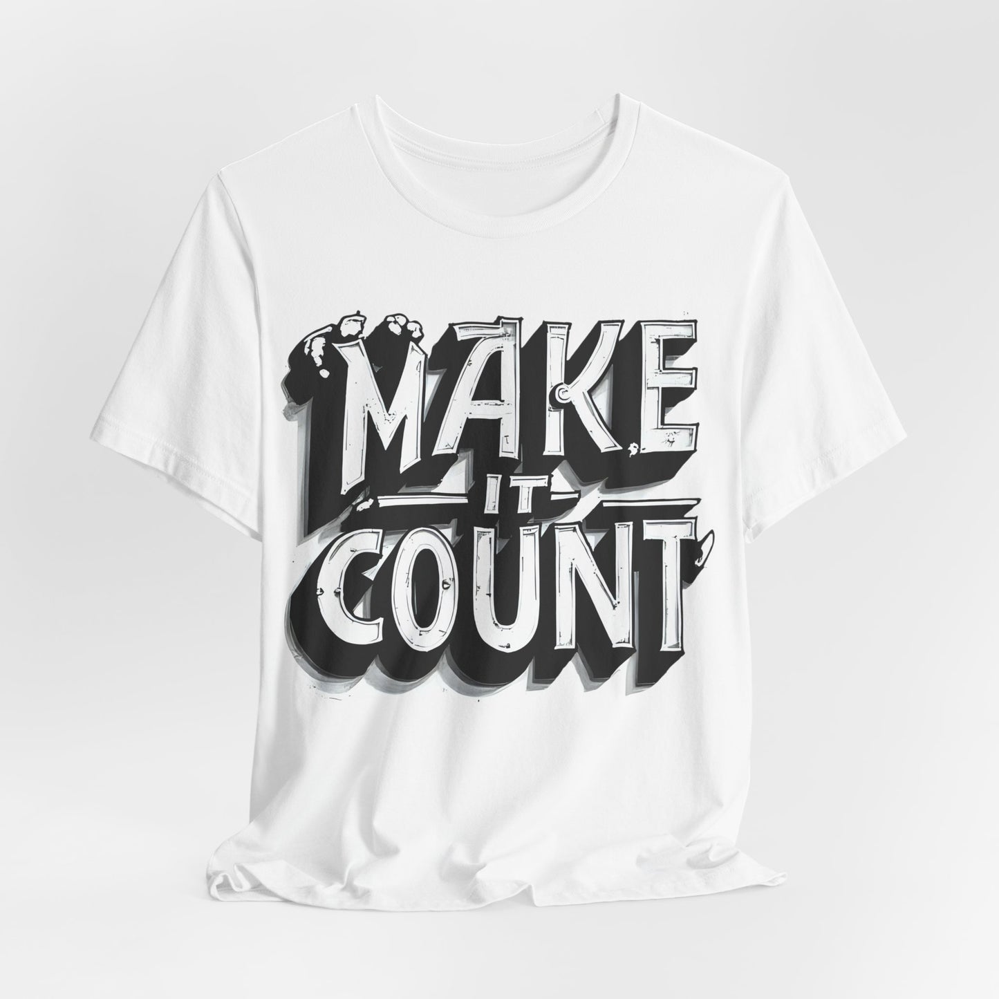 White t-shirt with 'MAKE IT COUNT' text design on a light gray background