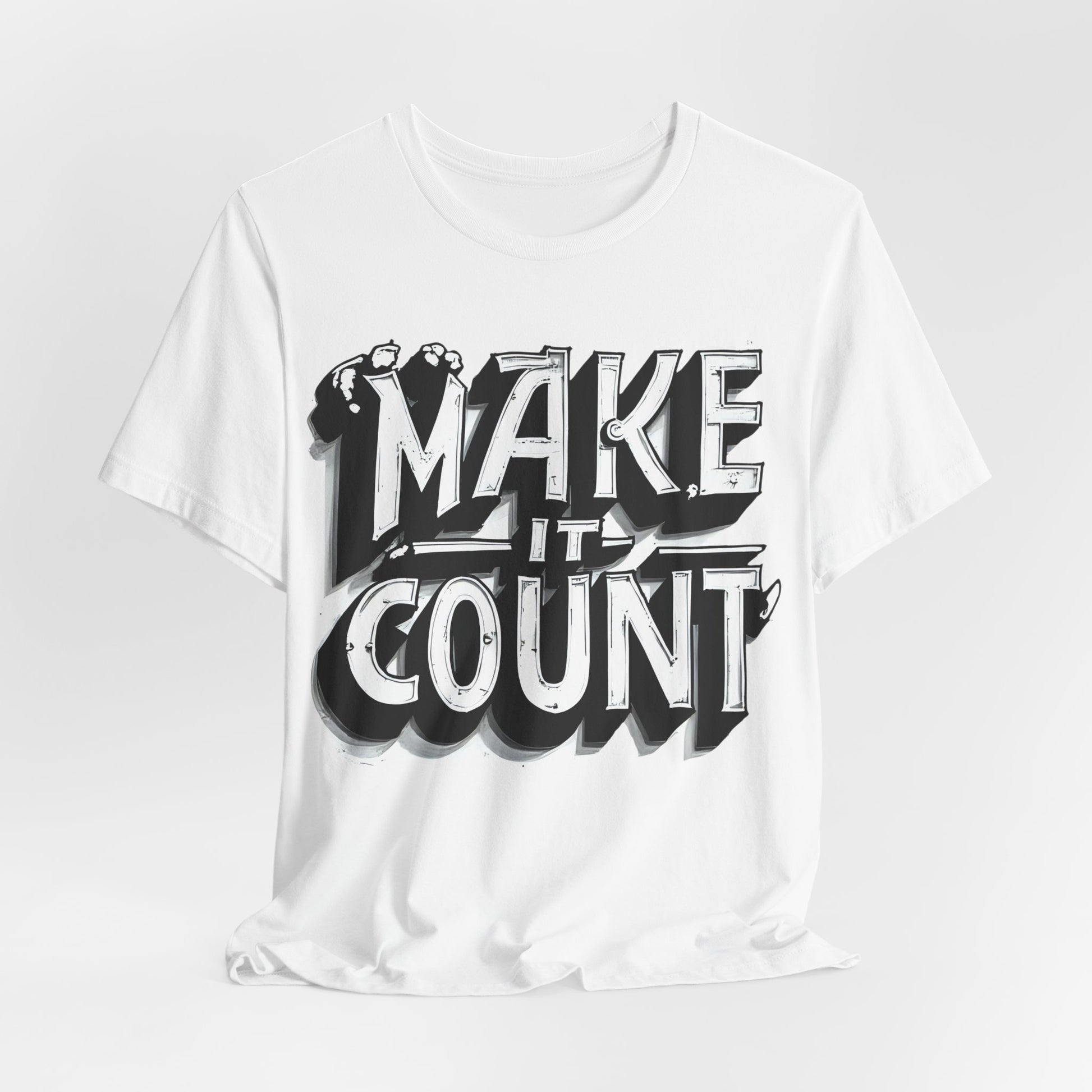 White t-shirt with 'MAKE IT COUNT' text design on a light gray background