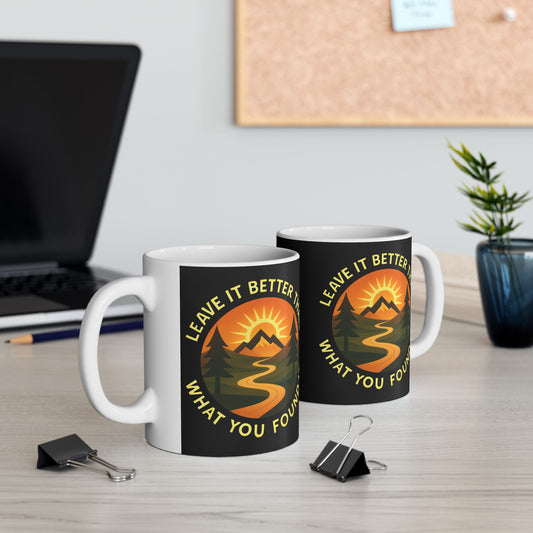 Two mugs with nature-themed designs on a desk with office supplies.