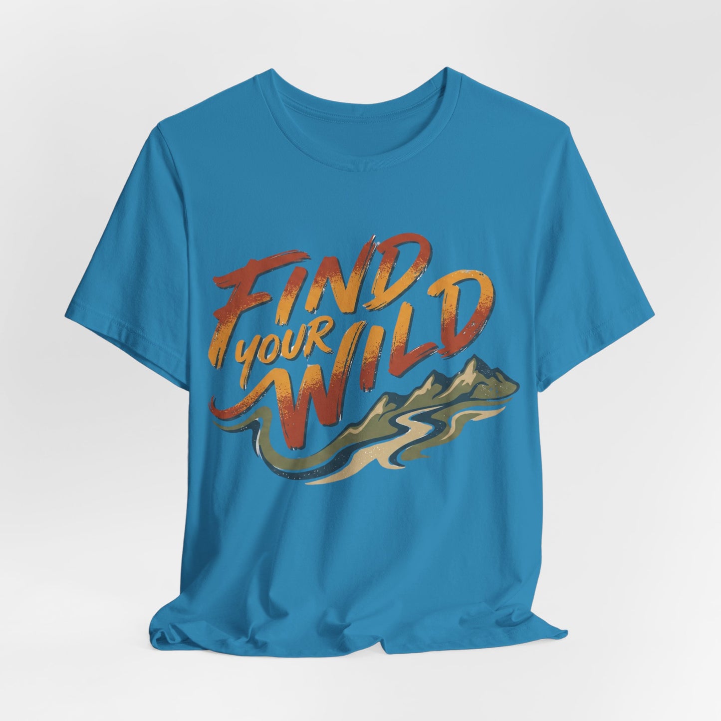 Blue t-shirt with 'Find Your Wild' text and mountain graphic on a light gray background