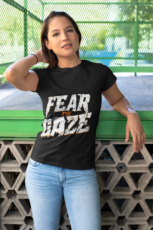 Black unisex T-shirt with bold Fear the Gaze slogan in distressed white and orange text, WonderTrail.Co motivational adventure apparel for explorers, outdoor lifestyle fashion, and wildlife lovers.