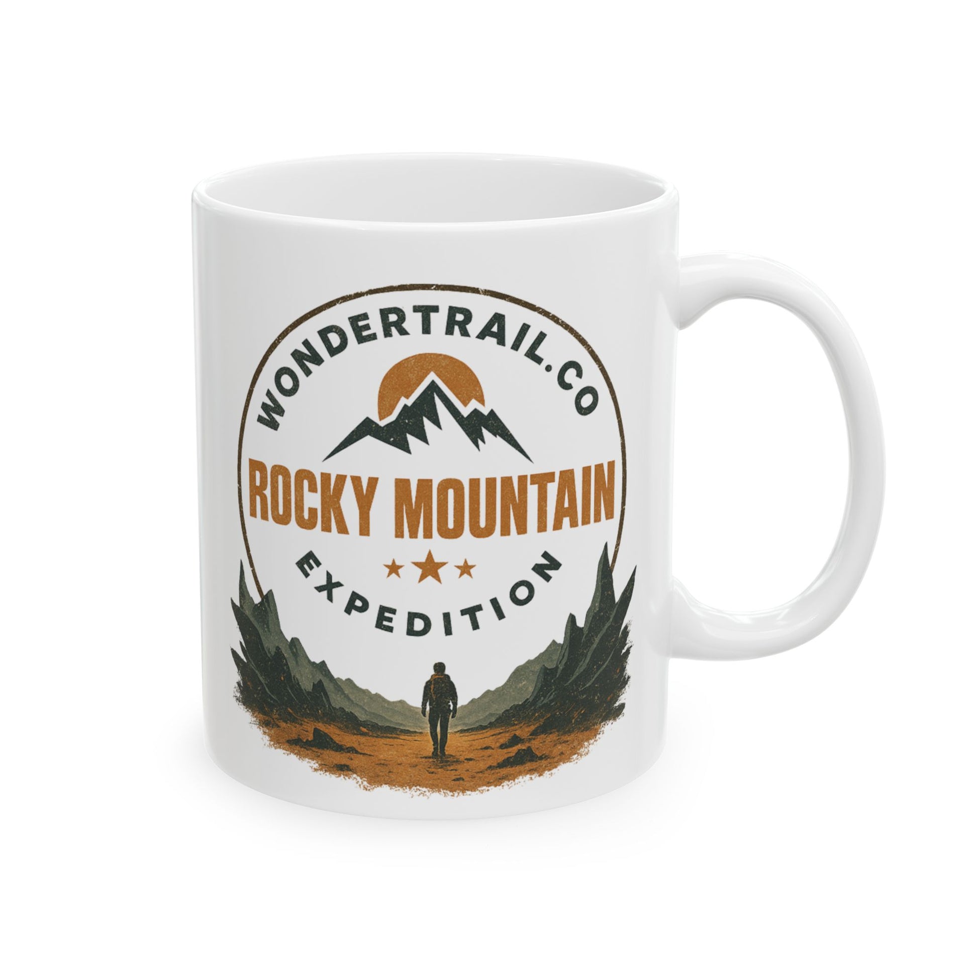 White ceramic mug with Rocky Mountain Expedition design featuring mountains, sun, stars, and hiker silhouette, WonderTrail.Co outdoor adventure camping mug — rustic gift for hikers and nature lovers